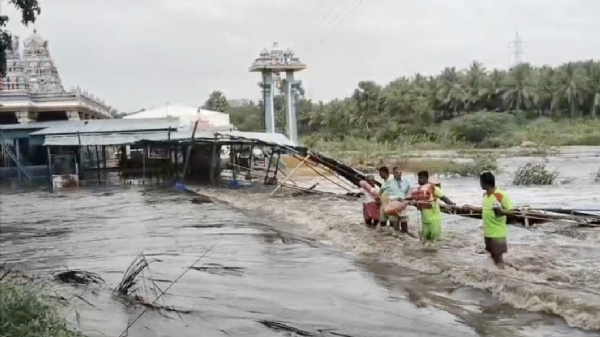 Two security guards who were trapped in the floods near the Palaar riverbank at the Anjaneyar Temple in Pollachi were rescued by the fire and rescue personnel after a long struggle.