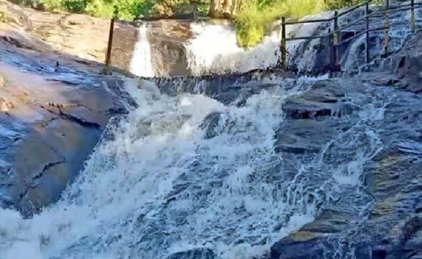 Tourists enjoy an enthusiastic bath at Kumbakkarai Falls. Tourists enjoy an enthusiastic bath at Kumbakkarai Falls.